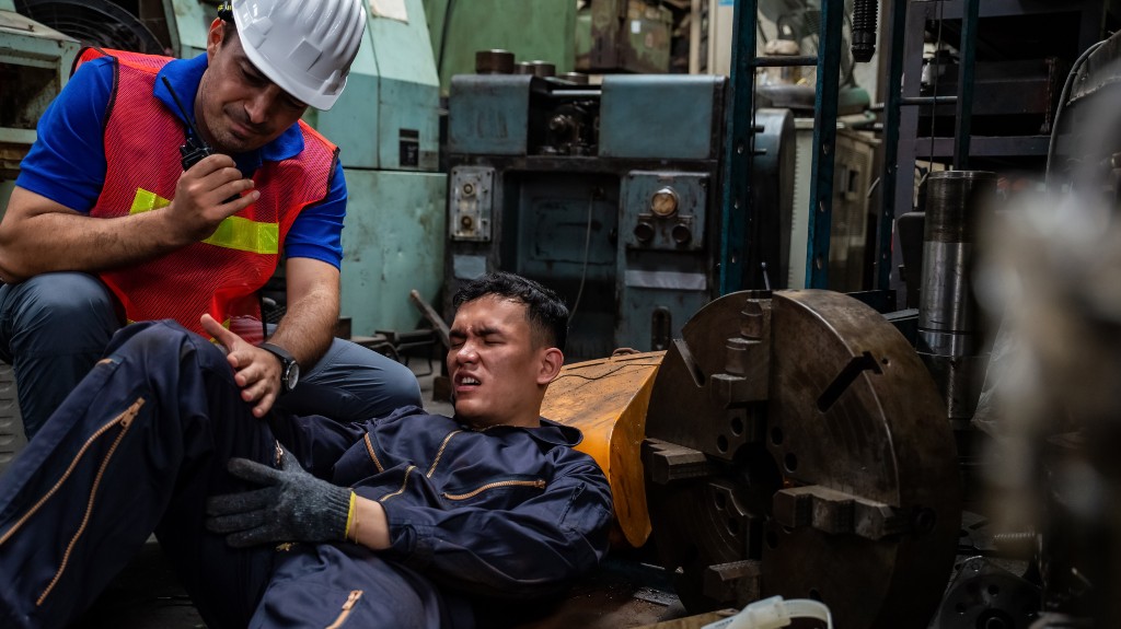 Man hurt on the job with a safety worker calling it in