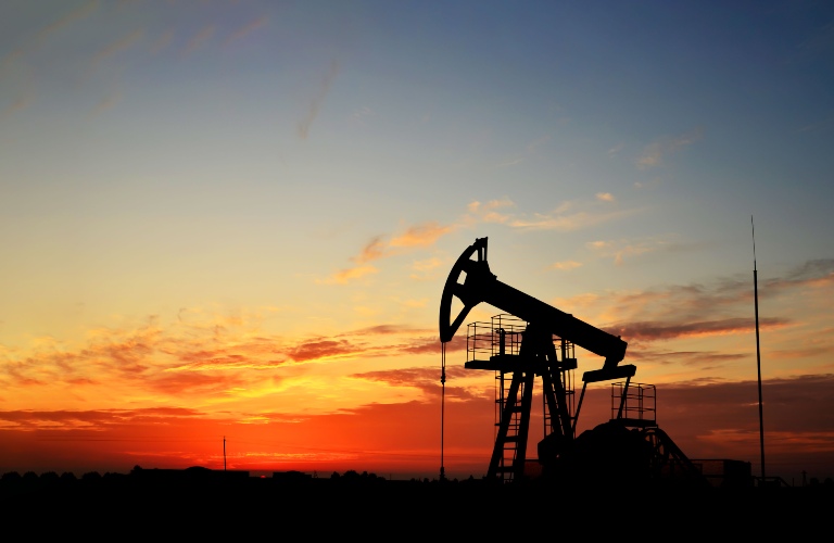 Oil drilling derricks at desert oilfield